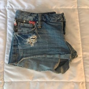Jean shorts with floral design.